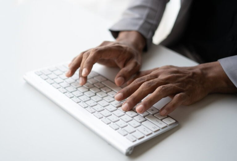 Hand typing message on keyboard laptop chatting friend search information form internet while workin